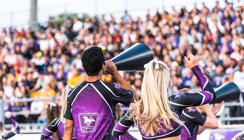 Cheerleaders leading an excited crowd cheering on the Western Mustangs Football Team at Western University in London, Ontario