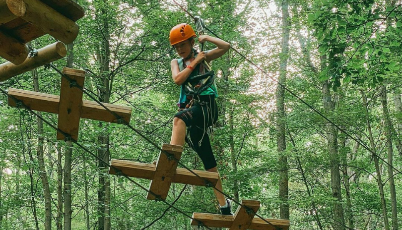 Individual climbing at the outdoor ropes course at Boler Mountain