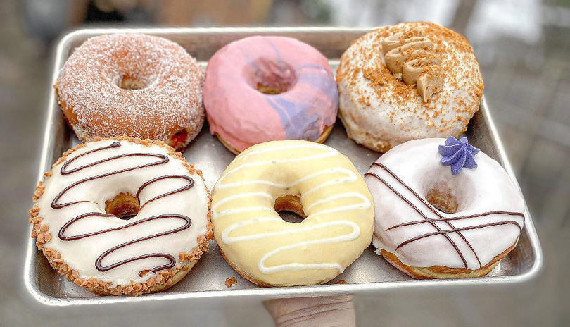 A selection of six donuts on a tray from Boxcar Donuts