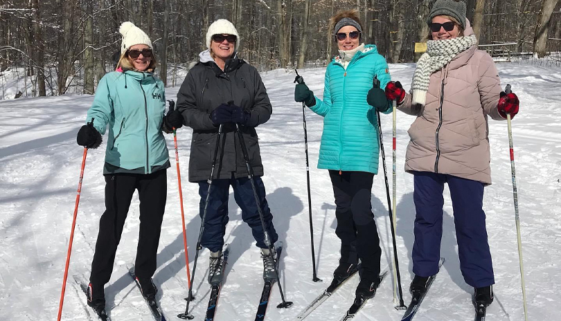 4 Skiiers standing for a picture at Circle R Ranch in London, Ontario