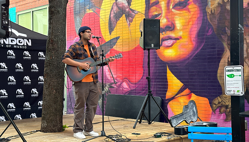 Artist Jey Khamari performing in Market Lane at the City of Music Concert Series