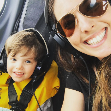 Nicole and her son wearing headphones