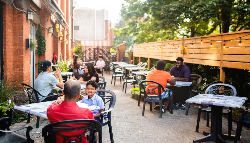 Outdoor Patio full of people enjoying meals and drink form the Church Key Bistro in London, Ontario