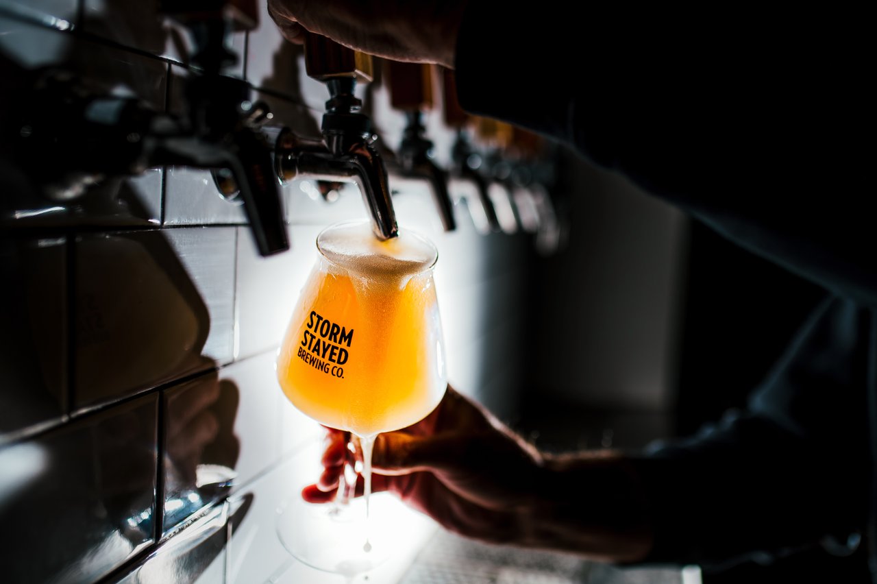 Person pouring beer at Storm Stayed Brewing Company