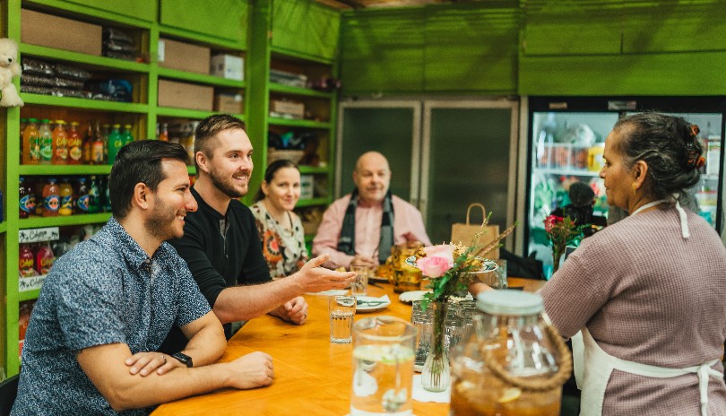 A small group of people ordering some food from a vendor in Covent Garden Market located in London, Ontario