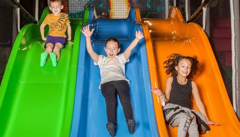 Children playing on slides at The Factory in 100 Kellogg Lane