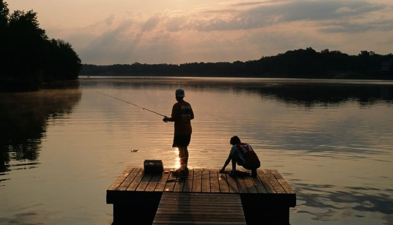 Boy fishing at Fanshawe Conservation Area during sunset