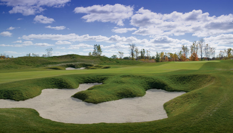 Image of bunker and fairway with tree line in background at FireRock Golf Club