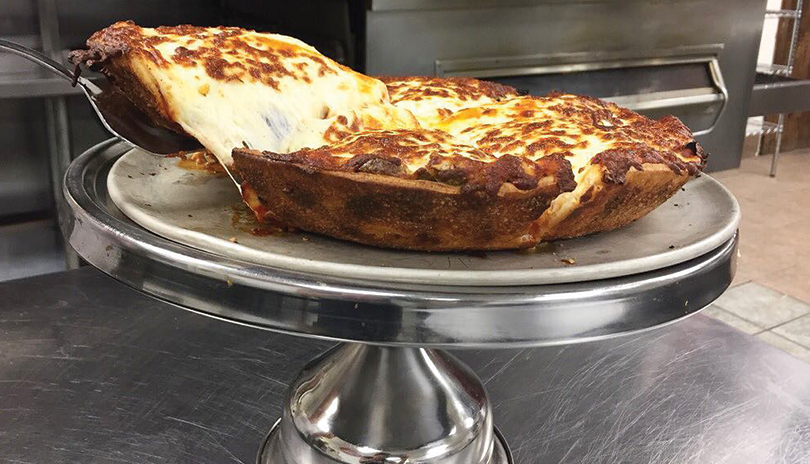 deep dish pizza on a tray