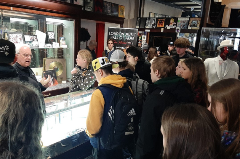 A group of people looking at historic musical artifacts on display at The London Music Hall of Fame located in London, Ontario