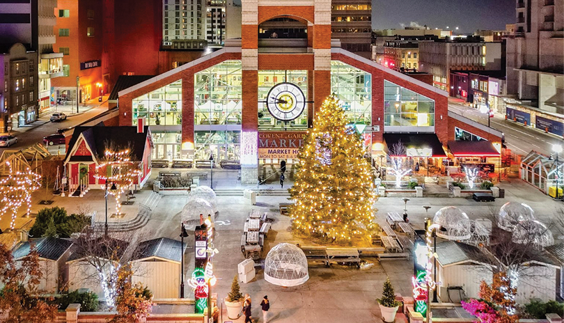 Aerial view of Covent Garden Market outdoors with a large decorated tree lit up for the holidays and various outdoor vendors surrounding it, located in London, Ontario