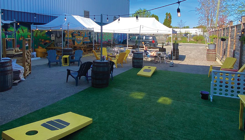 London Brewing outdoor patio with games, chairs, lights and tents