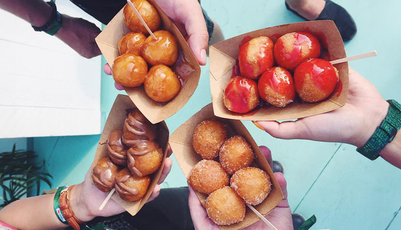 Four people enjoying doughy snacks at Mr puffs