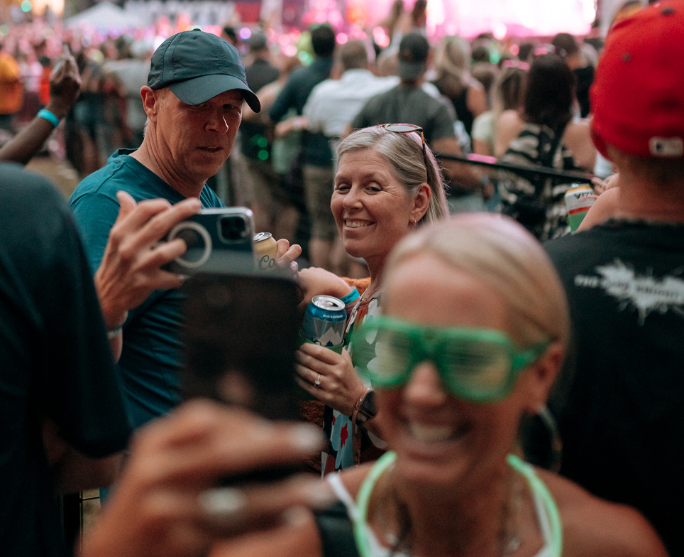 3 people taking selfies with mobile phones