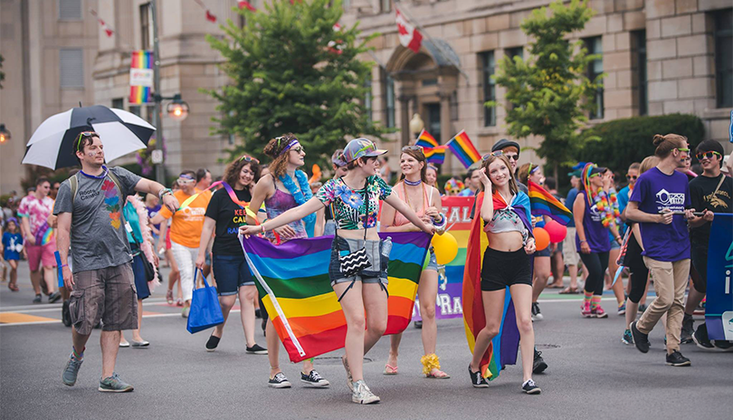 Pride Parade Festival with many people waving rainbow flags