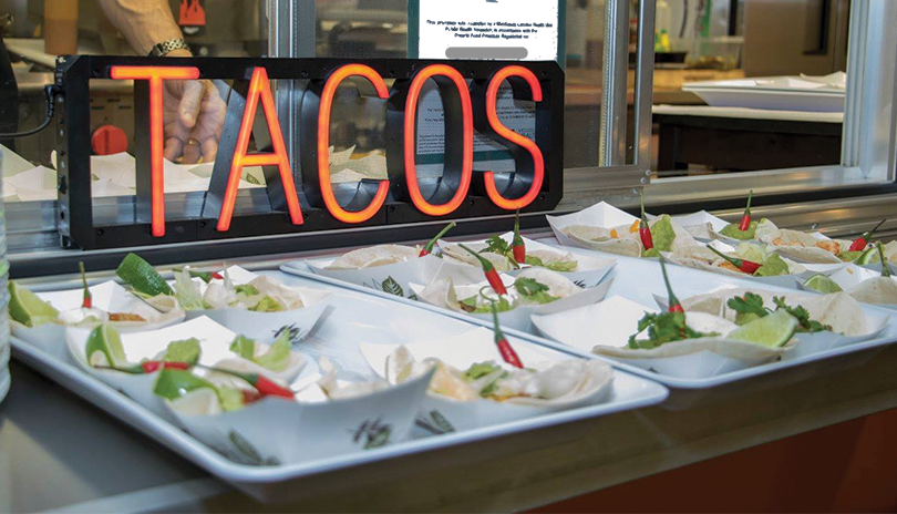 Tacos lined up on a tray