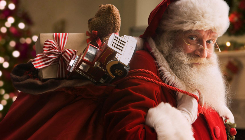 Santa Claus holding a bad of presents