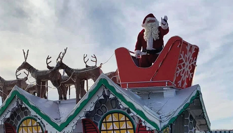 Santa Claus waves from his sleigh at the London Santa Claus Parade