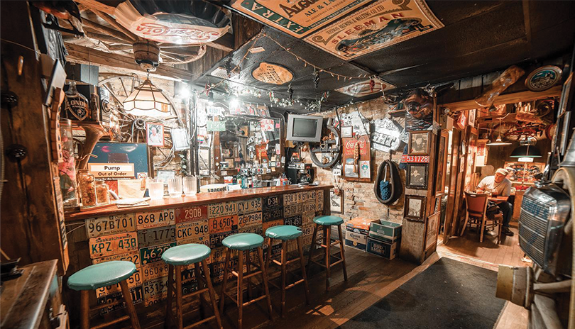 Inside interior of Spageddy Eddy's restaurant featuring license plates and eclectic memorabilia on the wall