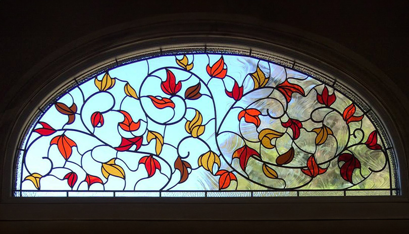 Stainglass window containing fall leaves