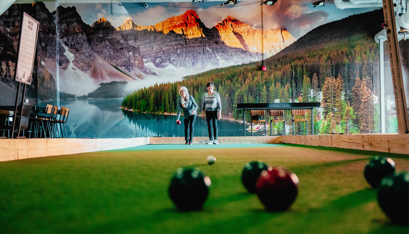 Two people playing bocce ball at the Clubhouse in London, Ontario