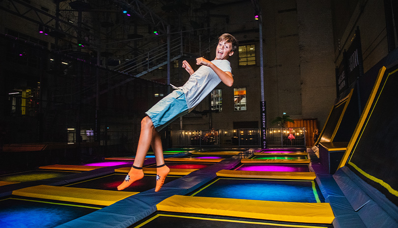 Child bouncing in the trampoline park of the Factory at 100 Kellogg Lane