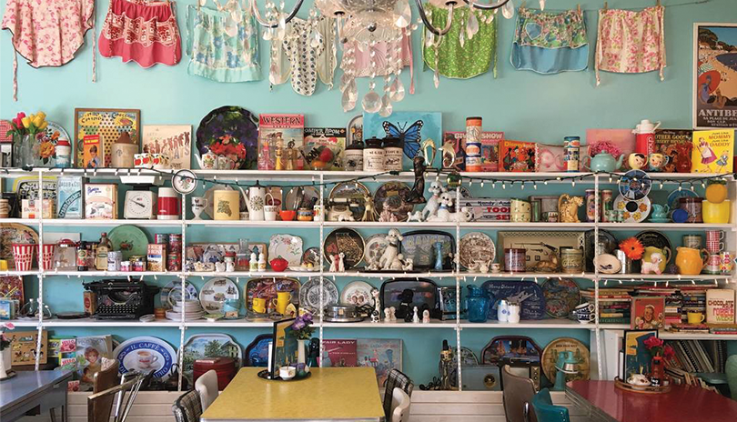 multiple shelves with dishes and nick nacks on display