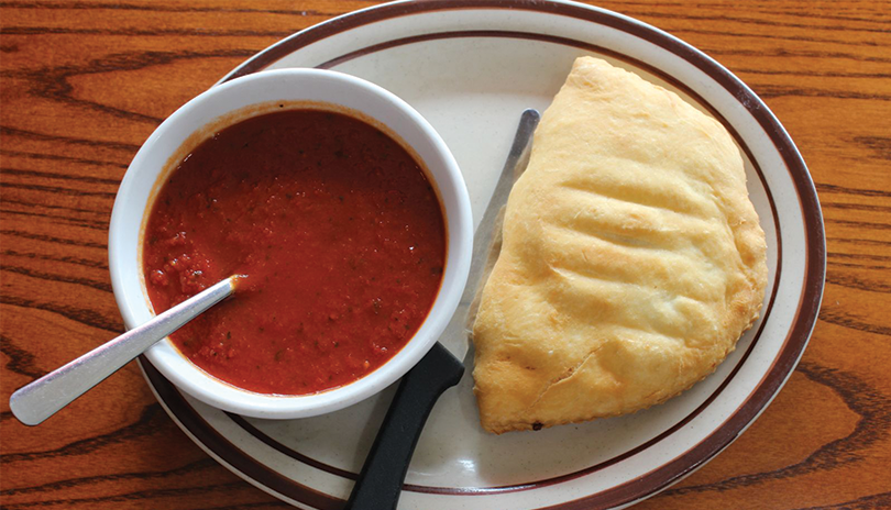 Panzerotti and sauce on a plate