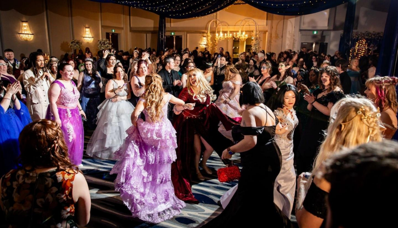 A ballroom filled with attendees in fairytale outfits at Love Among The Pages.
