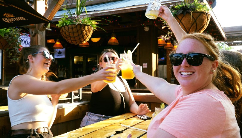Three females enjoying a beverage outdoors at Barney's Patio located in London, Ontario