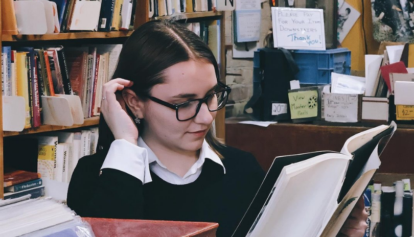 Person reads a book in City Lights Bookshop.