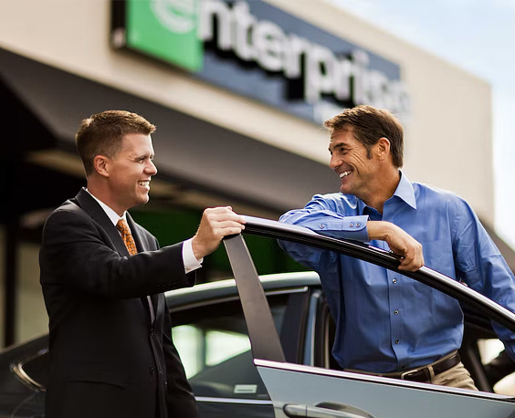 two people talking with a car door open