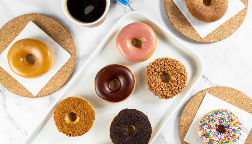 A view from above of a table full of different donuts from Fluffy Glaze in London, Ontario.
