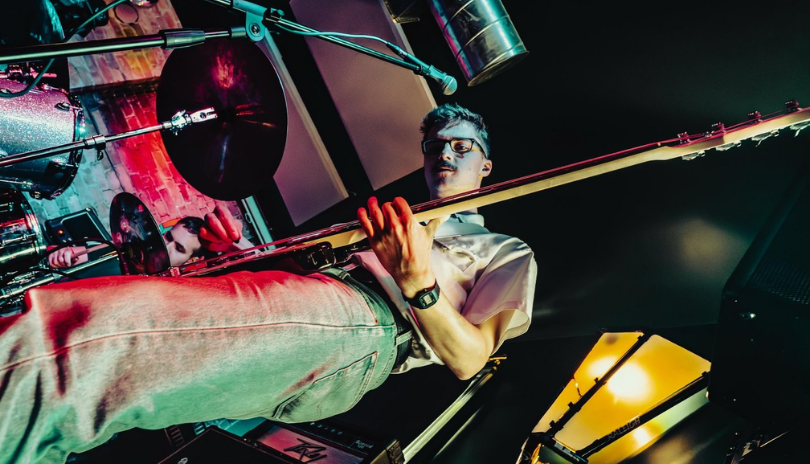 A low angle shot of a guitarist playing a concert at Honey Dip in London, Ontario.