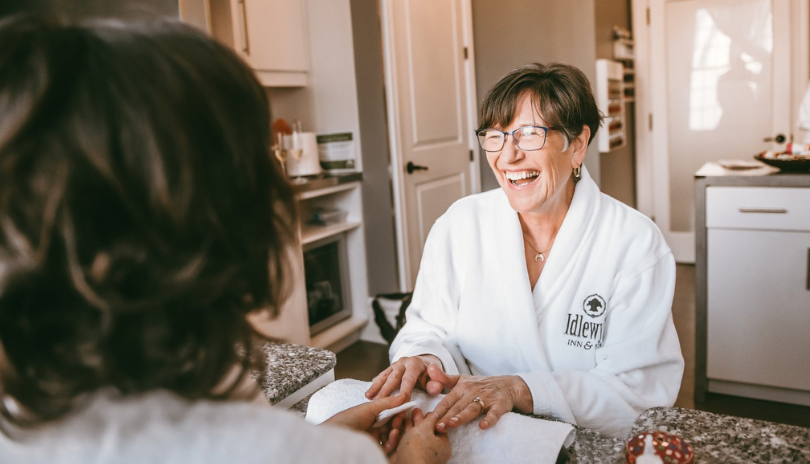An older woman smiles as she gets a manicure at Idlewyld Inn & Spa in London, Ontario.