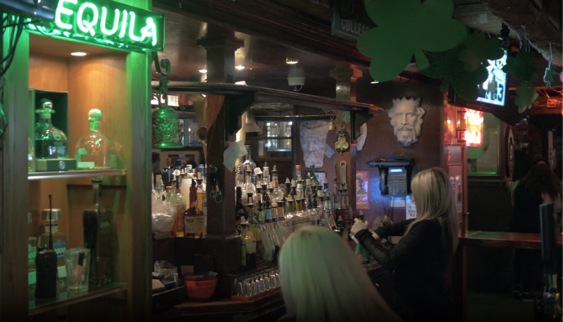 An Irish pub with neon green lighting in London, Ontario.