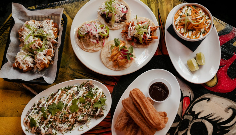 A table filled with dishes of delicious Mexican cuisine.