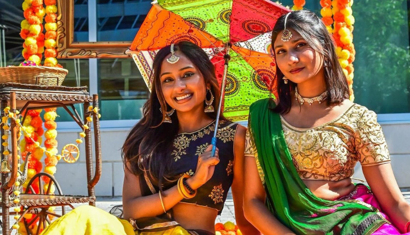 Two women in cultural clothing at South Asian Festival.