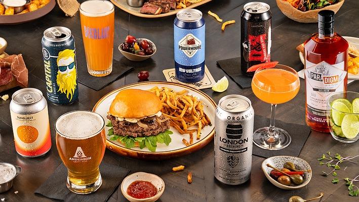 A table top view of various beers and pub type food from London, Ontario