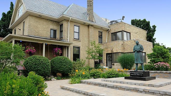 outdoor view of the Banting House National Historical Site building and flame of hope located in London, Ontario