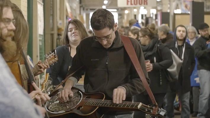 Musicians playing at the Western Fair Farmers Market with a crowd of people watching located in London, Ontario