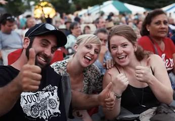 A large group of people attending an outdoor concert in London, Ontario