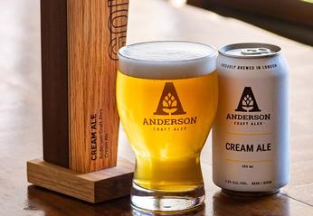 A glass filled with beer and can of cream ale beer from Anderson Craft Ales located in London, Ontario