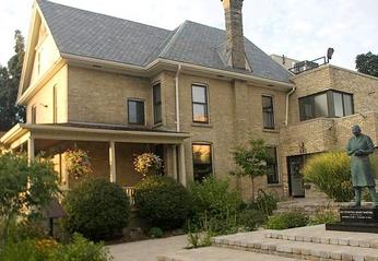 Exterior view of the Banting House National Historic Site of Canada's building and statue of Sir Frederick Grant Banting located in London, Ontario