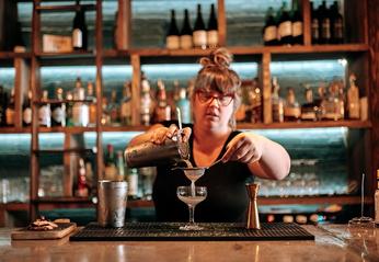 A female bartender preparing a mixed drink at Hunter & Co. located in London, Ontario