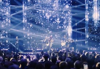 A band playing live on stage with a large crowd watching at the JUNO Awards