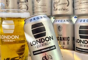 Cans of beer on display with a glass of beer from London Brewing located in London, Ontario