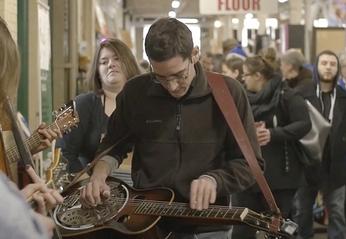 Musicians playing at the Western Fair Farmers Market with a crowd of people watching located in London, Ontario