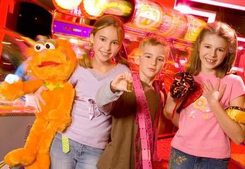 Three kids showing their prizes and winnings from the Palasad located in London, Ontario