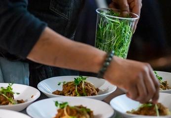 A chef preparing several dishes from Yaya's Kitchen located in London, Ontario